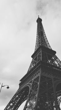Striking black and white photo of the Eiffel Tower from a low angle in Paris, France.