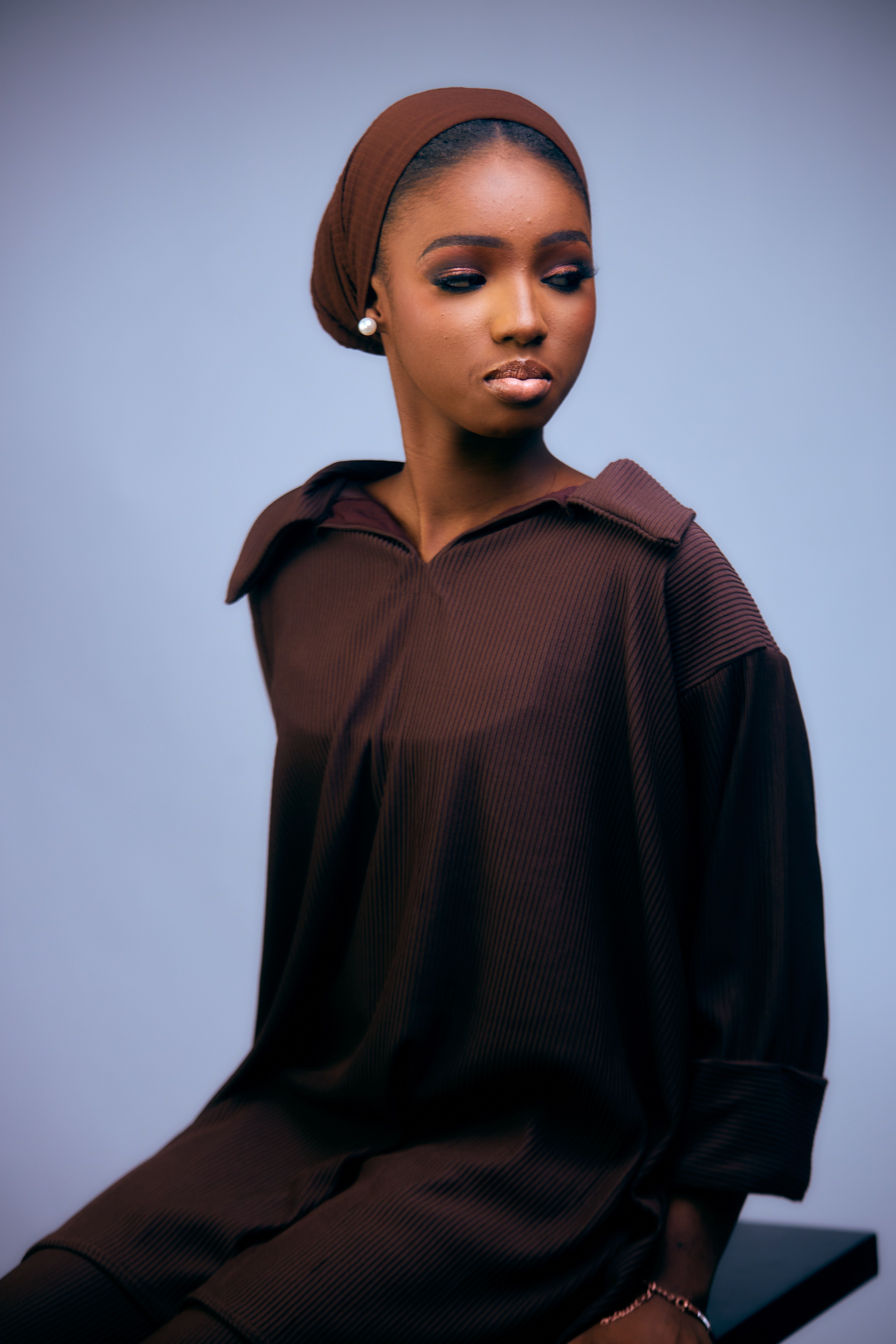 Elegant Portrait of a Woman in Brown Attire · Free Stock Photo