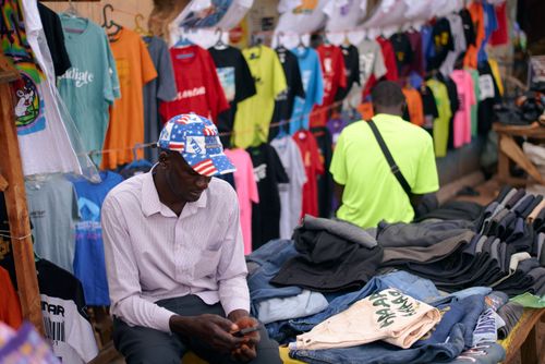 Free Explore the colorful evening market in Jos, Nigeria, featuring vibrant clothes and local sellers. Stock Photo