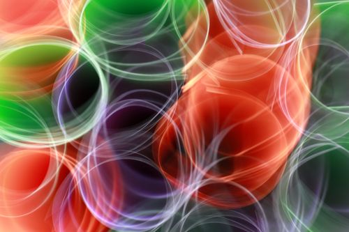 Free Dynamic abstract image featuring colorful light trails forming circular patterns. Stock Photo