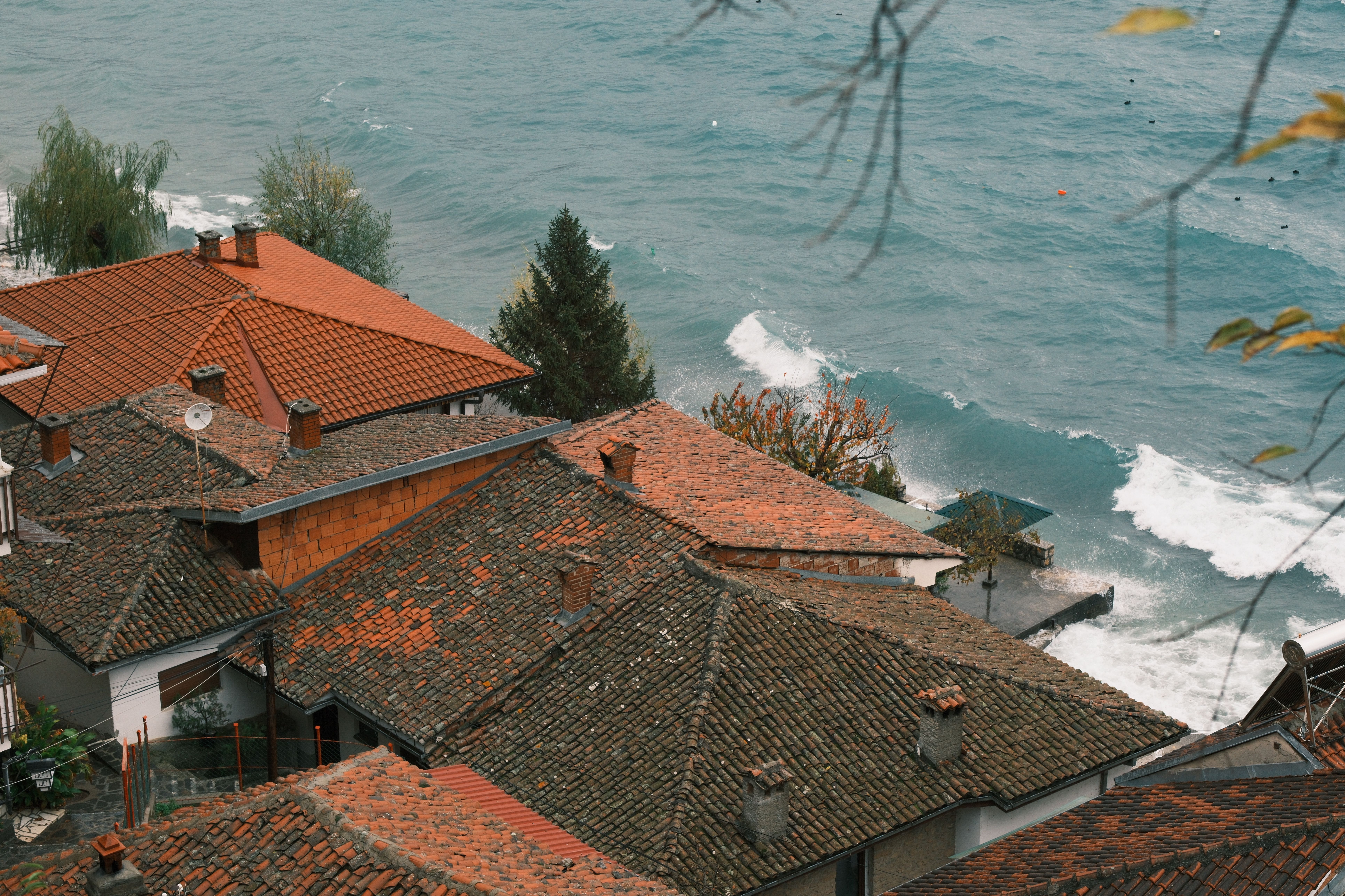 Charming Coastal Village Rooftops Overlooking Ocean · Free Stock Photo