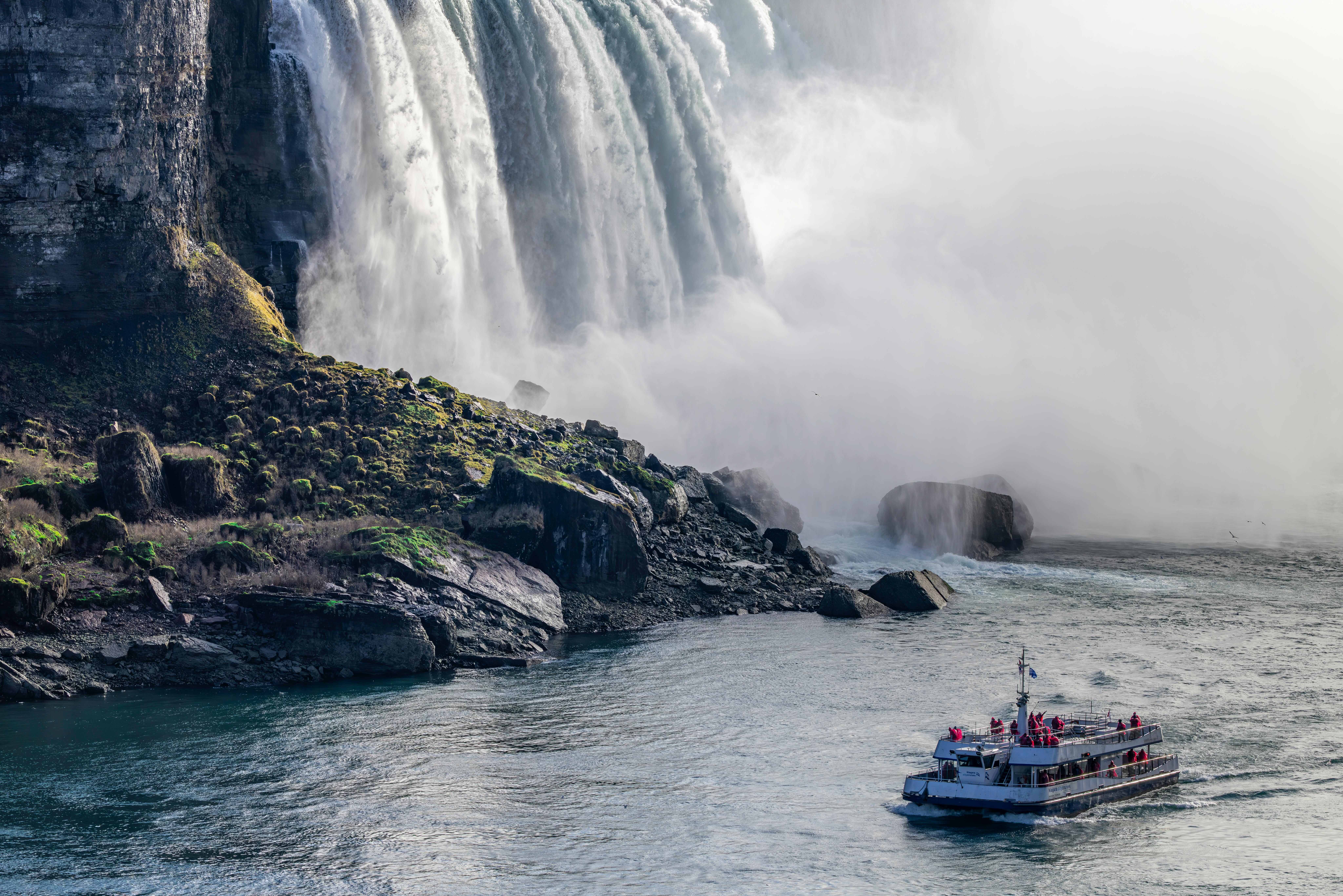 Tour boat near Niagara Falls cascading water, offering a stunning, misty view.