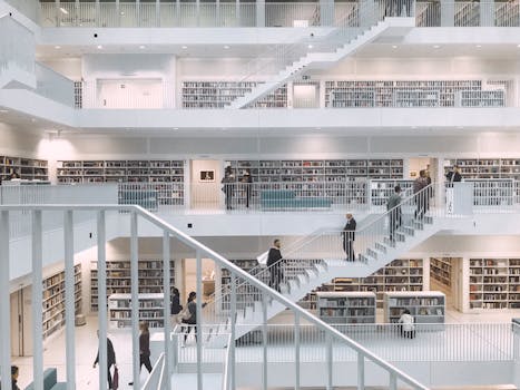 Spacious and minimalist design of the Stuttgart City Library showcasing multiple levels of books and people.
