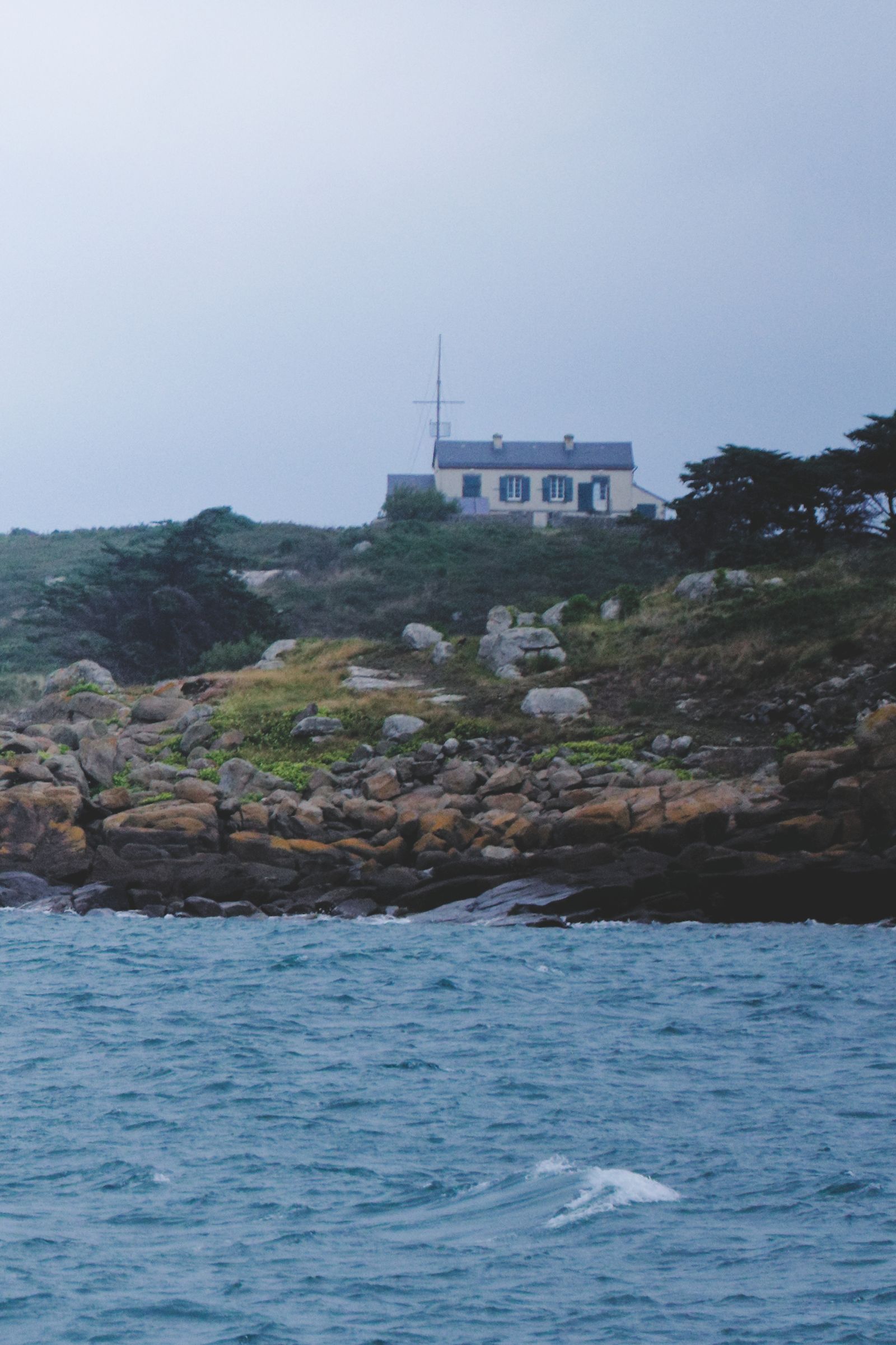 Scenic coastal house on Chausey Island's rocky shores in France