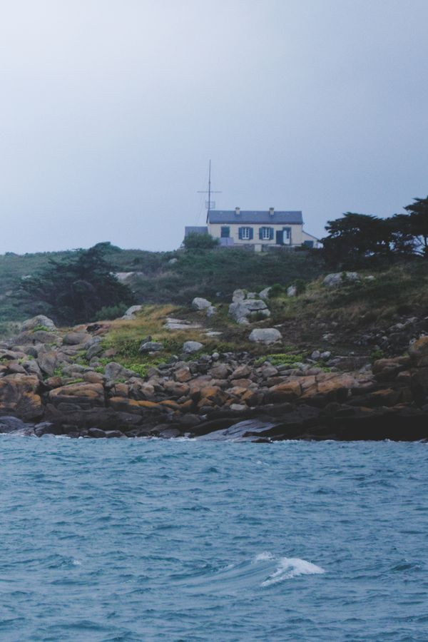 Scenic coastal house on Chausey Island's rocky shores in France