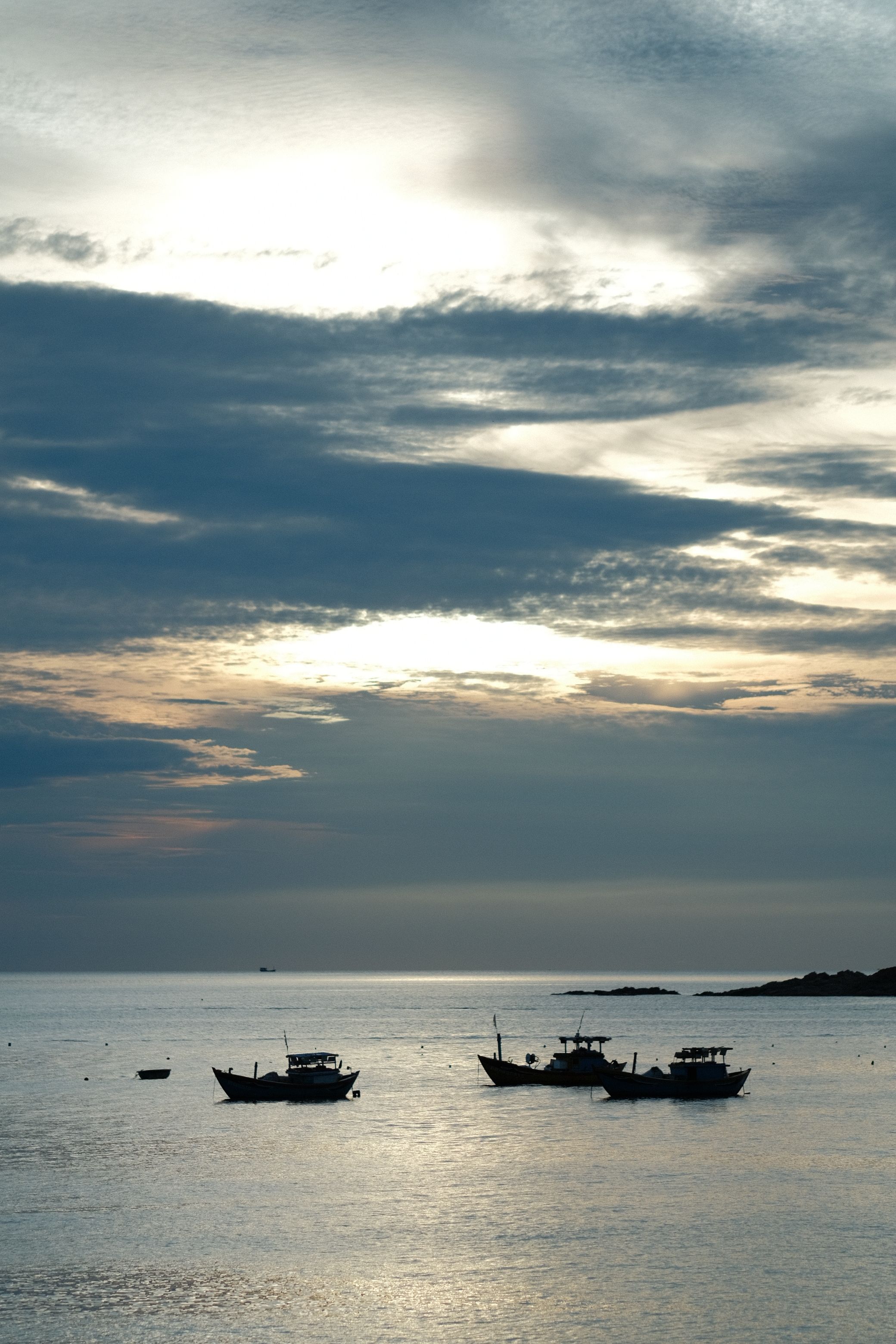 Serene Sunset Over Fishing Boats at Sea · Free Stock Photo