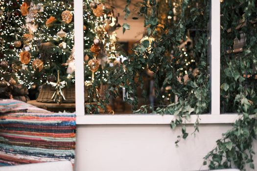 Warm indoor scene featuring Christmas tree with twinkling lights and festive decorations.