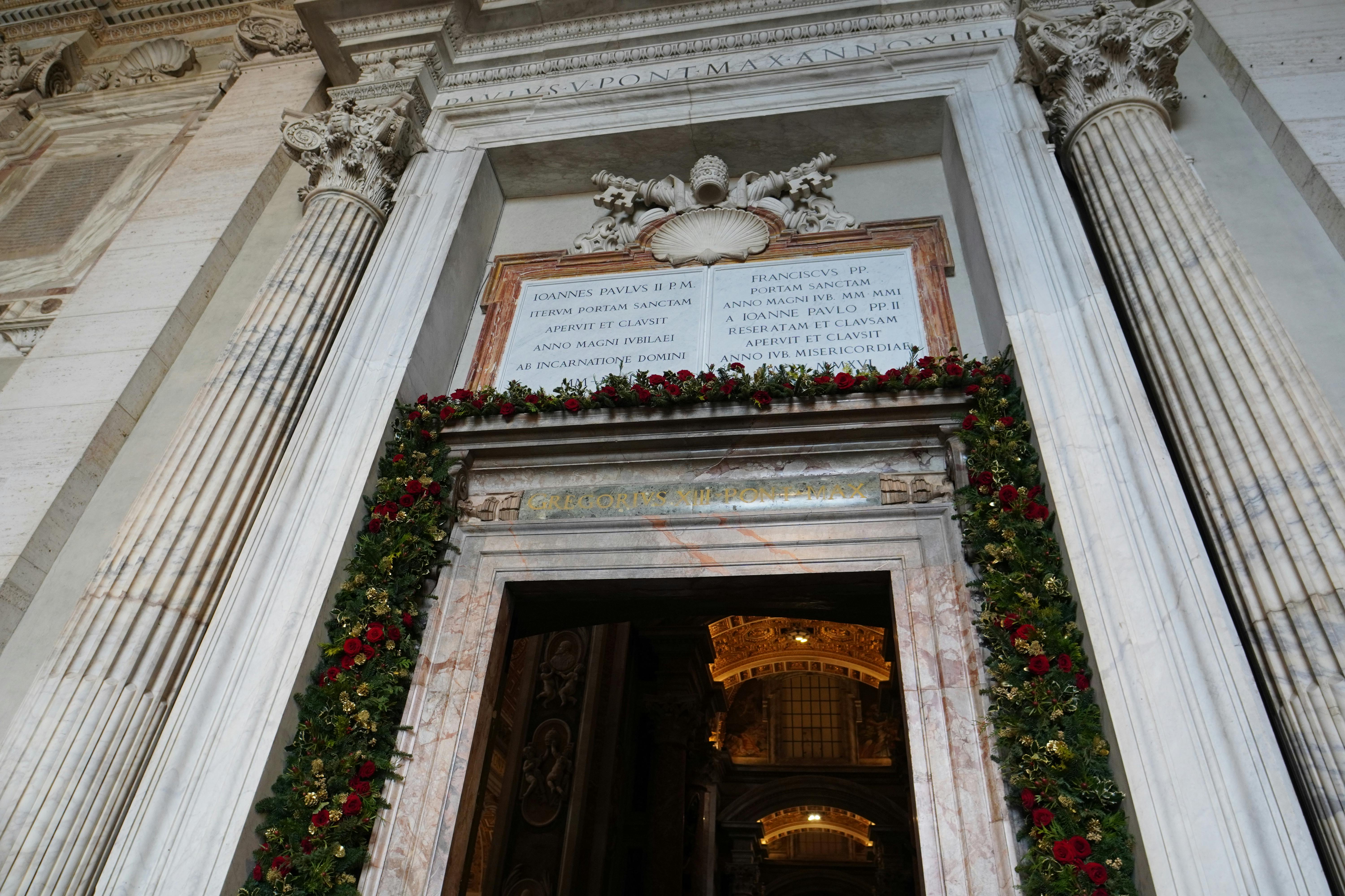 Stunning entrance of St. Peter's Basilica adorned with flowers, showcasing classical architecture.