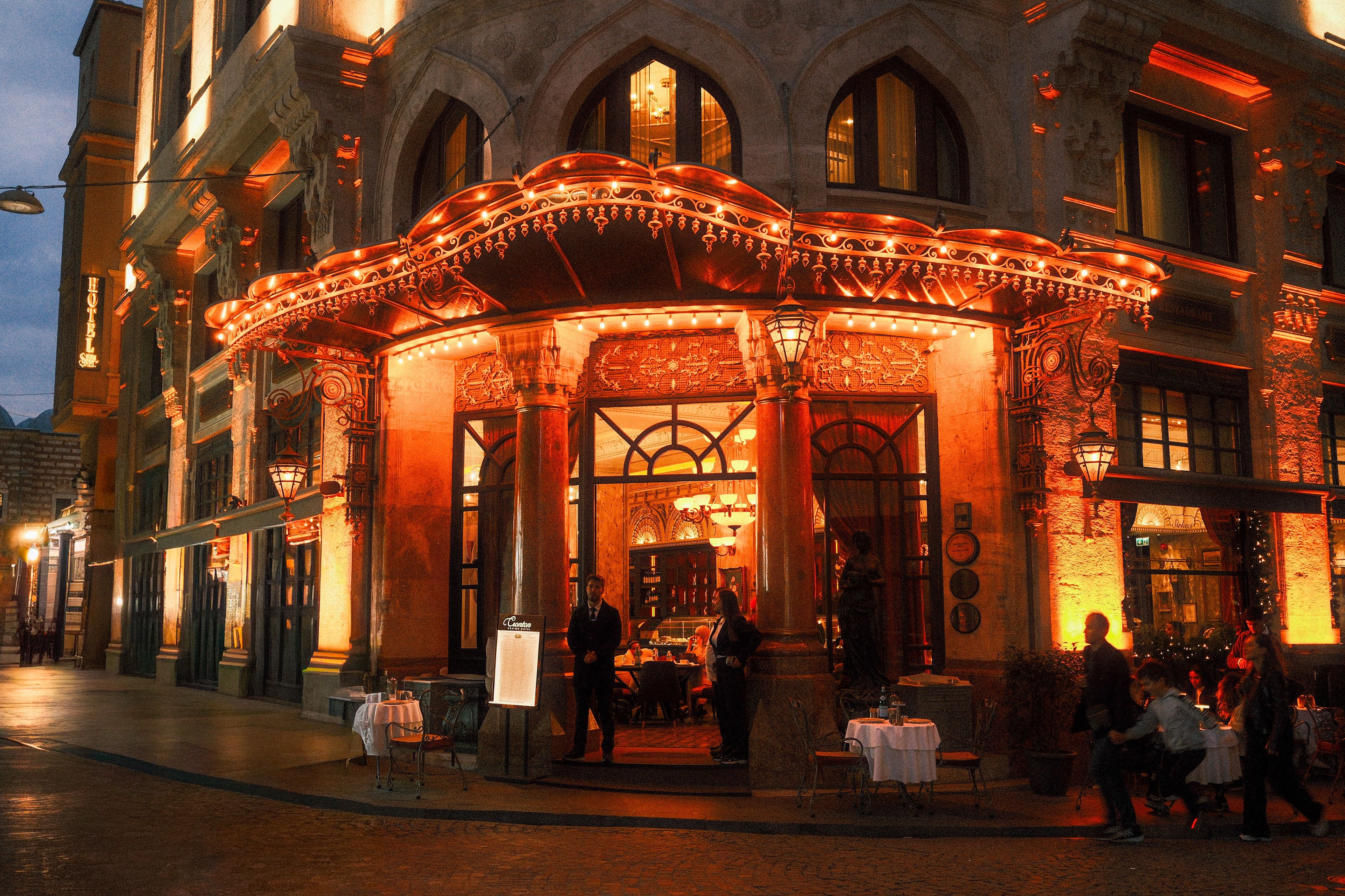 Charming vintage restaurant with warm lights and intricate architecture at night.