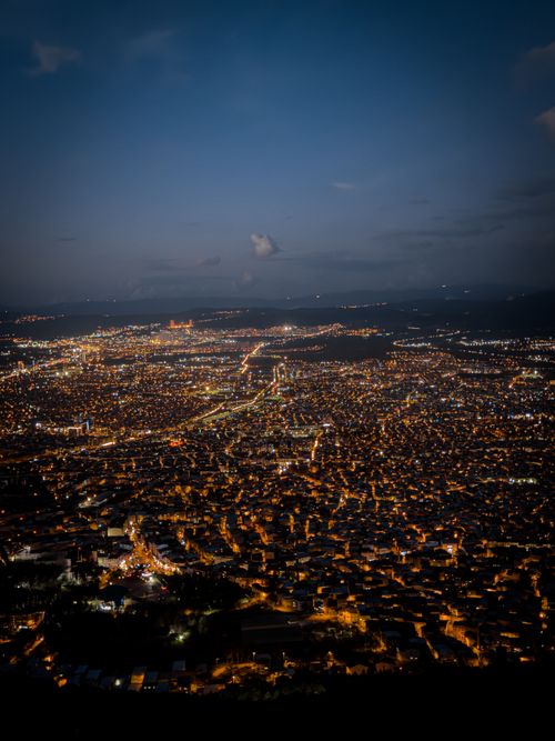Free Aerial view of a brightly lit cityscape at night, showcasing urban lights. Stock Photo