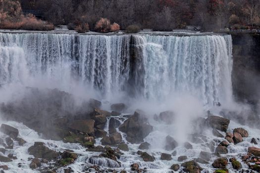 Stunning capture of Niagara Falls waterfall with mist and rocks.