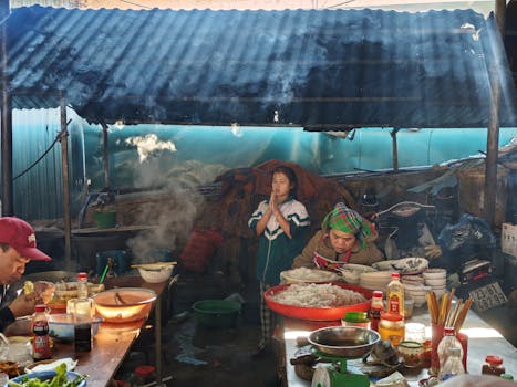 Bustling Vietnamese market scene with locals preparing and enjoying food.