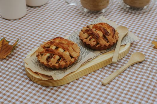 Delicious mini apple pies on checkered cloth, perfect for a cozy fall picnic.