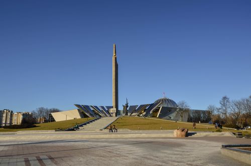 Free Wide shot of the Victory Monument in Minsk, showcasing its modern architecture under a clear blue sky. Stock Photo