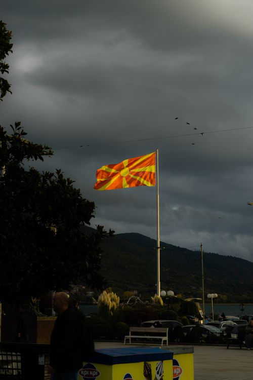 Free Dramatic view of the North Macedonian flag in Ohrid against a cloudy sky. Stock Photo