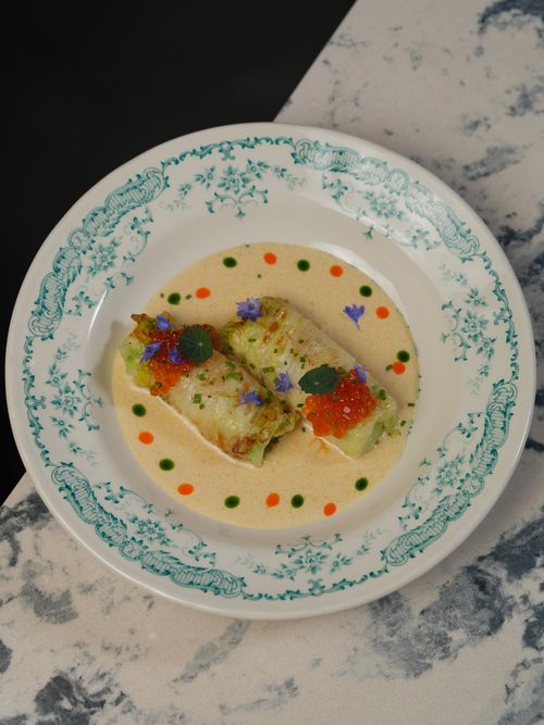 Free Elegant gourmet fish dish with ikura and edible flowers on a decorative plate. Stock Photo