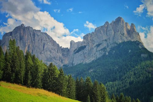 Free A breathtaking summer view of the majestic Dolomites and lush forests in Canazei, Italy. Stock Photo
