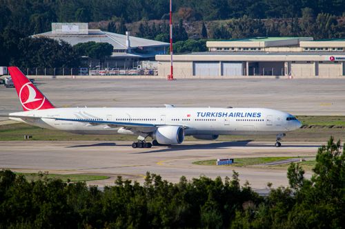 Free Turkish Airlines Boeing 777 taxiing on the runway at a sunny airport day. Stock Photo