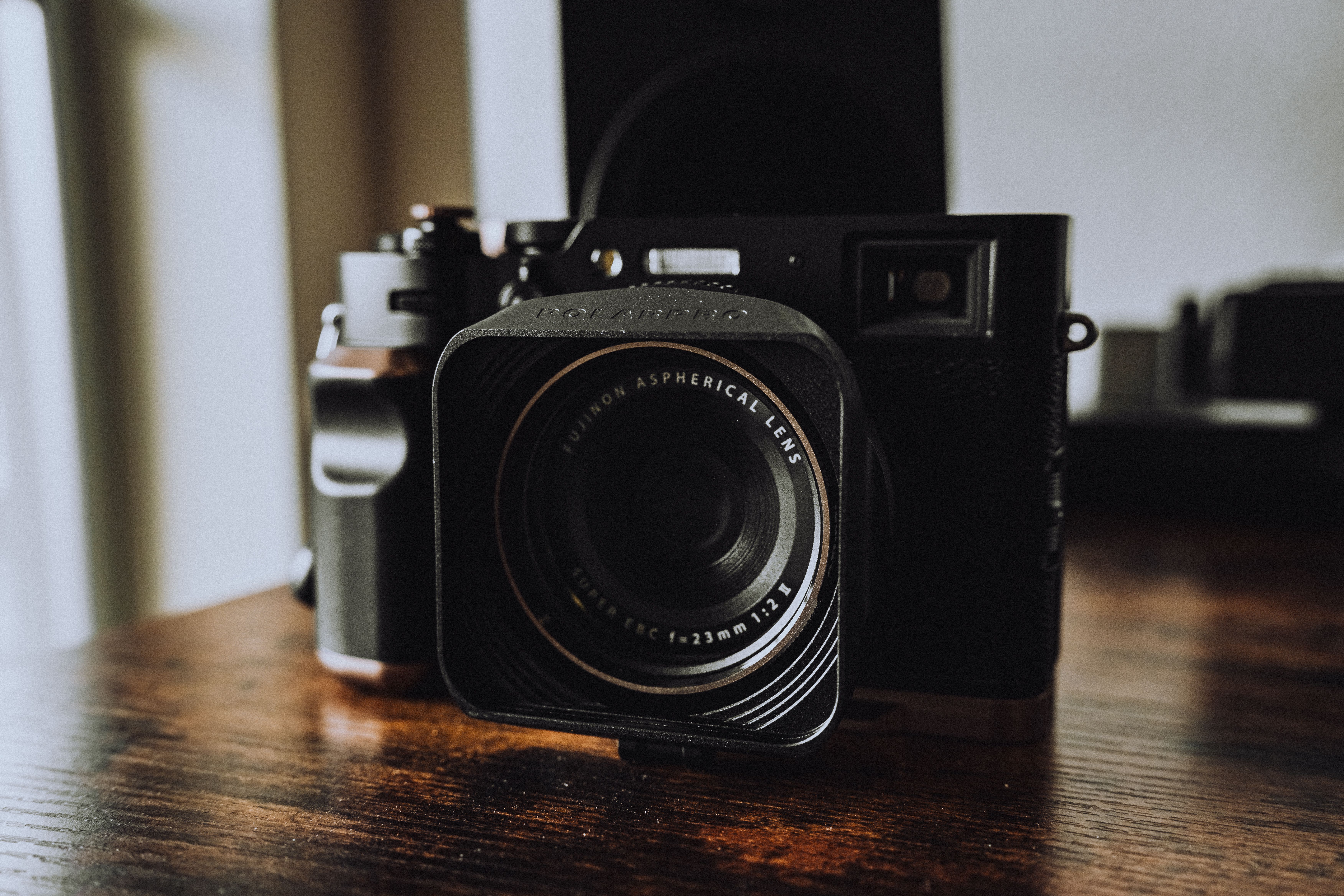 Vintage Camera on Wooden Surface in Soft Lighting · Free Stock Photo