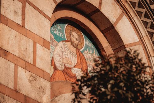 Free Close-up of a religious icon on a Serbian church's exterior wall, showcasing ancient design. Stock Photo