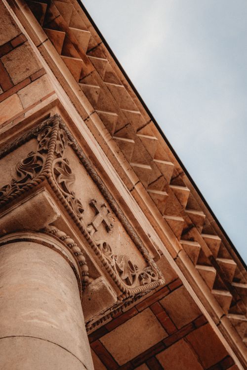 Free A close-up view of the ornate architectural details of a historic church, showcasing its classical design. Stock Photo