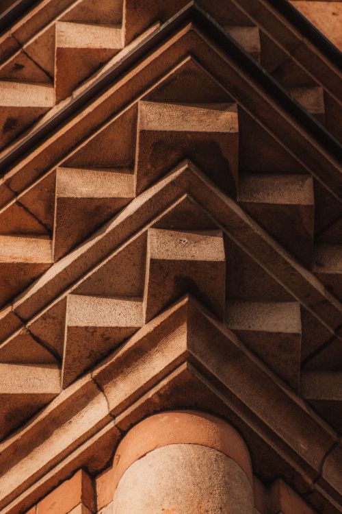 Free Close-up shot of intricate design elements on a historic building's facade, featuring geometric patterns. Stock Photo