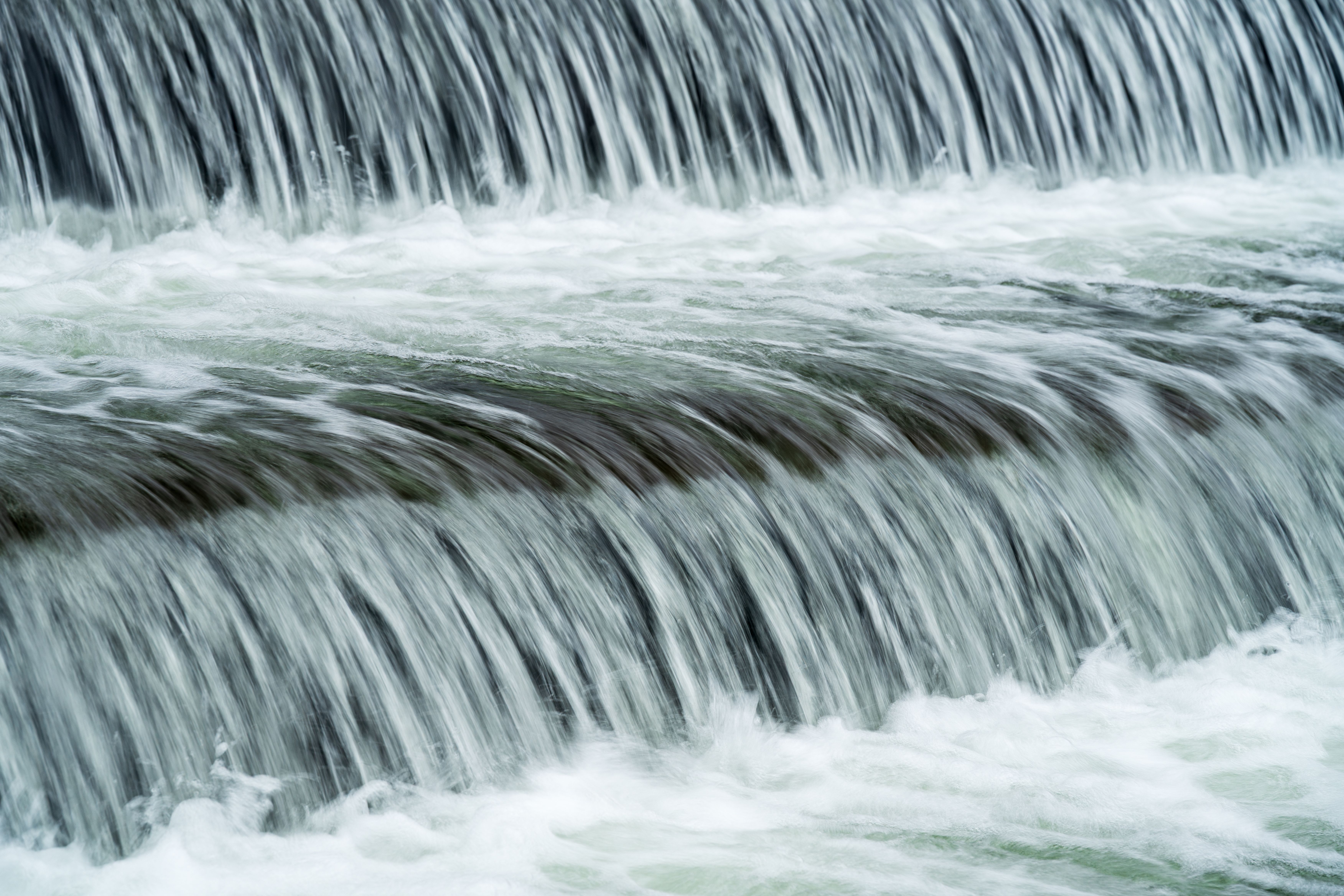 Close-up of cascading waterfall in Myślenice, Poland, capturing the serene flow of water.