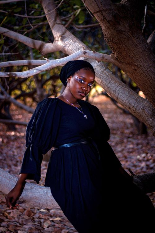 Free Artistic portrait of a woman in nature, with ethereal makeup under dim forest light. Stock Photo