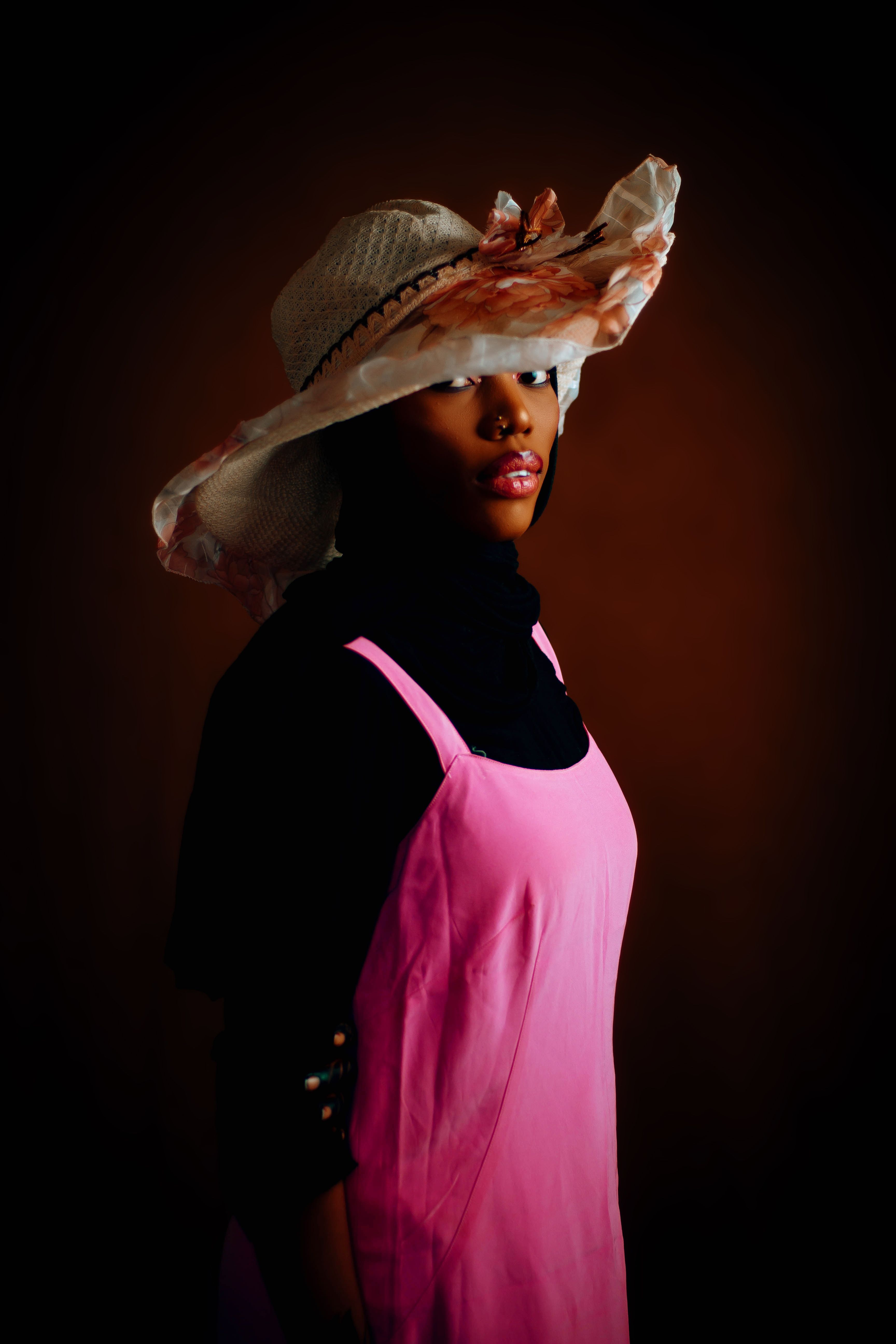 Elegant Woman in Pink Dress and Floral Hat · Free Stock Photo