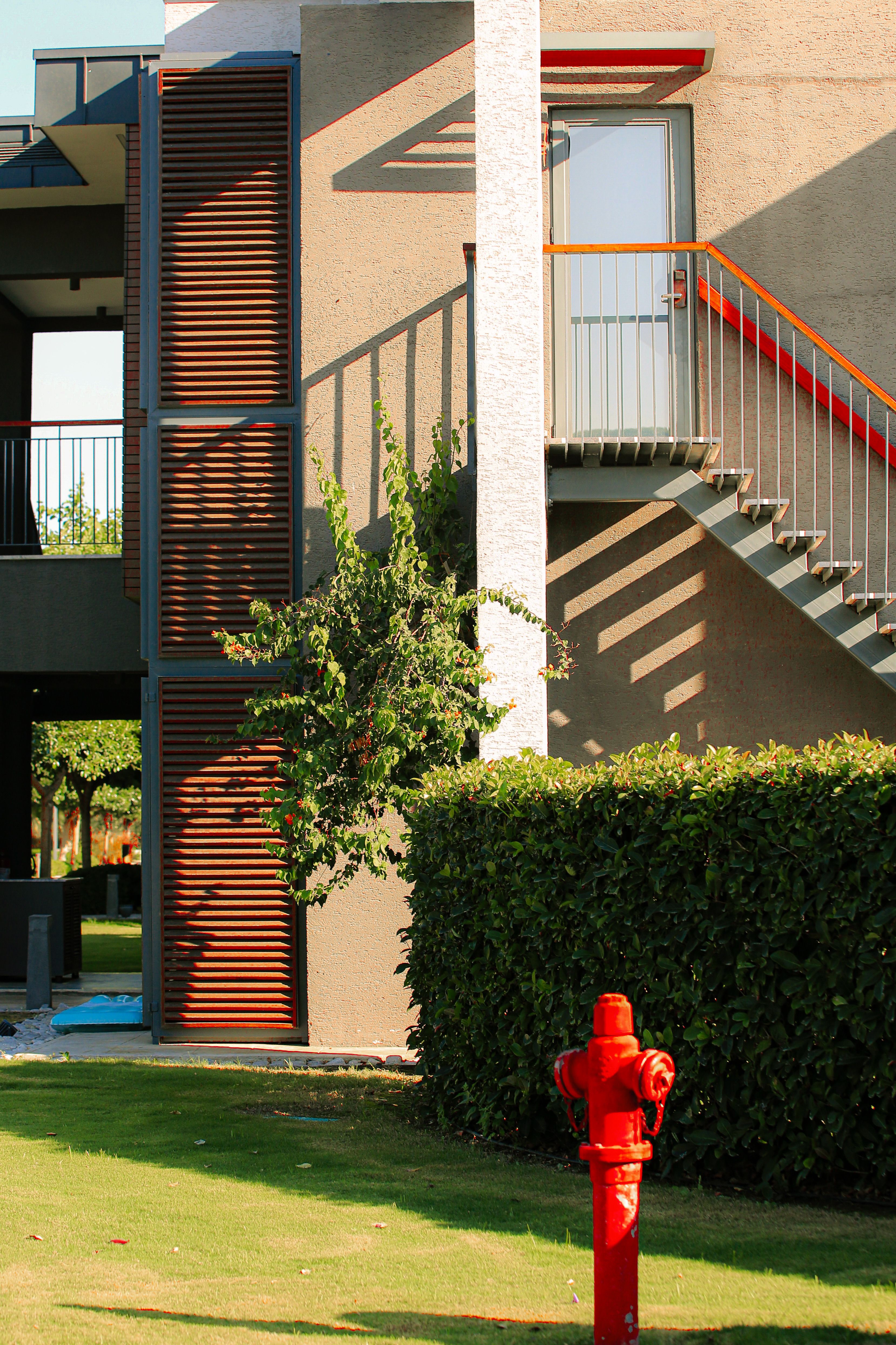 Modern Building Exterior with Red Fire Hydrant · Free Stock Photo