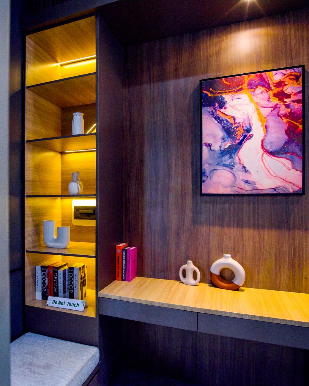 A contemporary interior featuring abstract art, wooden shelves, and elegant decor.