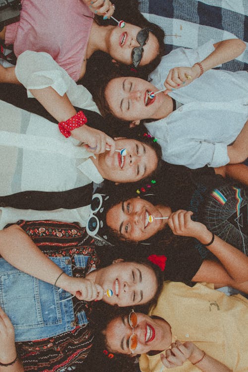 Free Women Lying Down Eating Lollipop Stock Photo