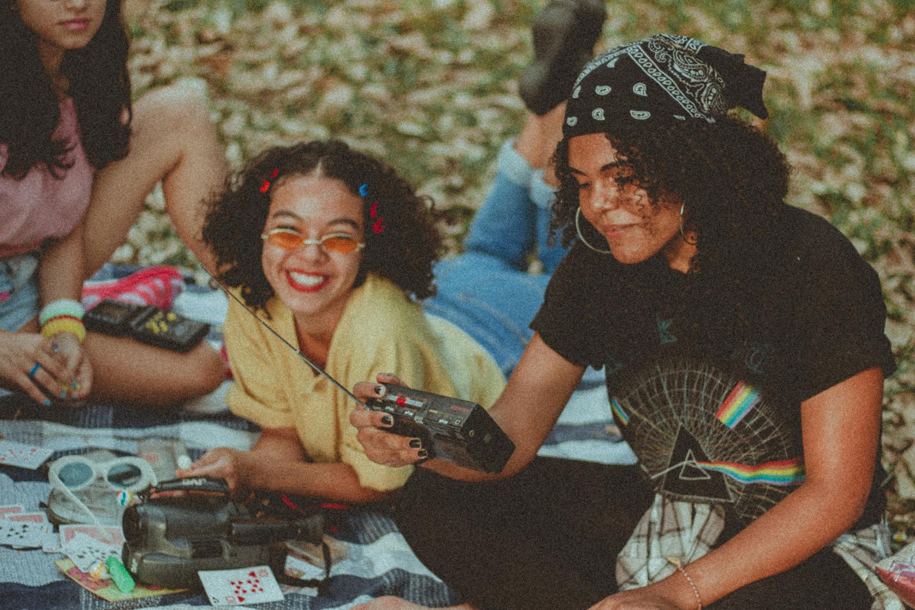 women holding crank radio