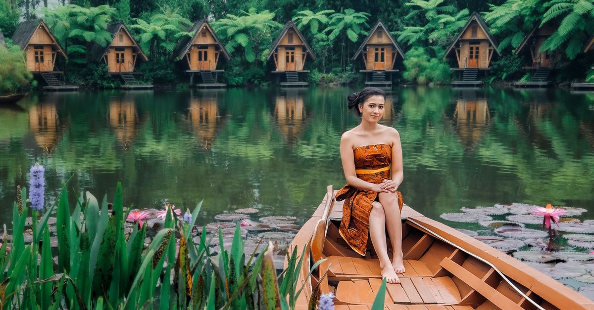 Serene Lake with Traditional Houses in West Java ยท Free Stock Photo