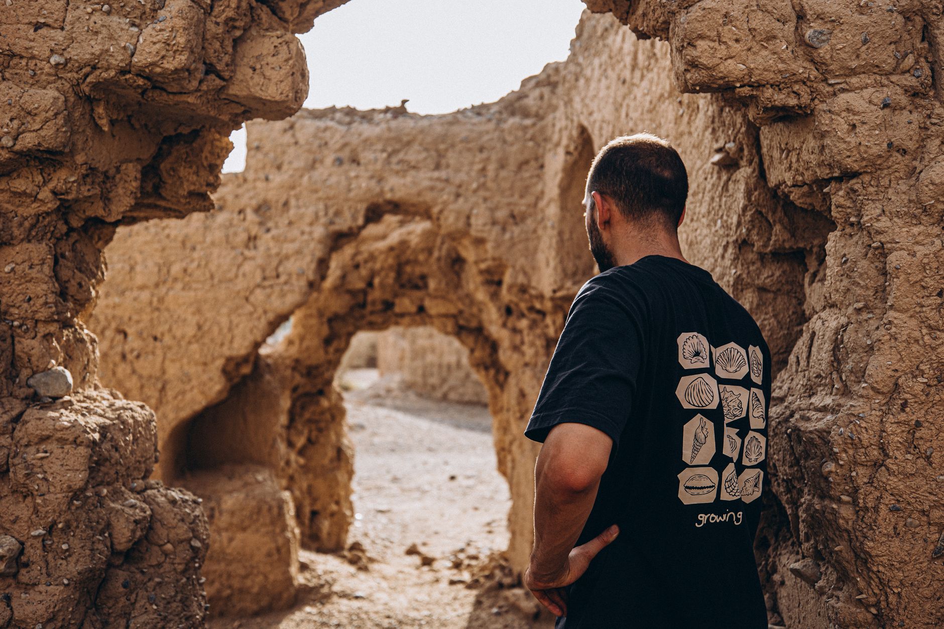 Man explores old ruins in Oman, capturing the essence of history and adventure.
