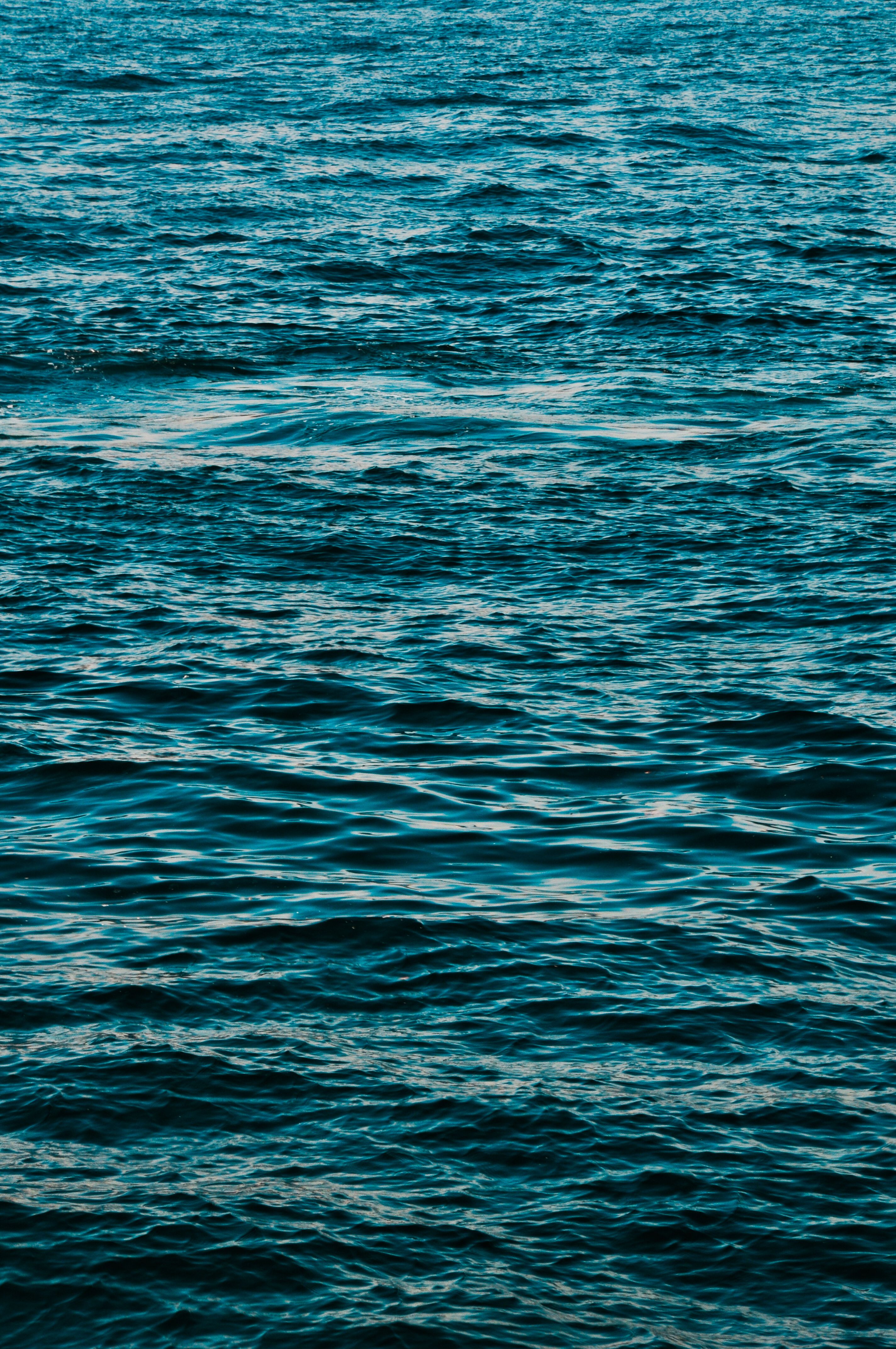 Tranquil deep blue ocean water with gentle waves creating a peaceful scene.