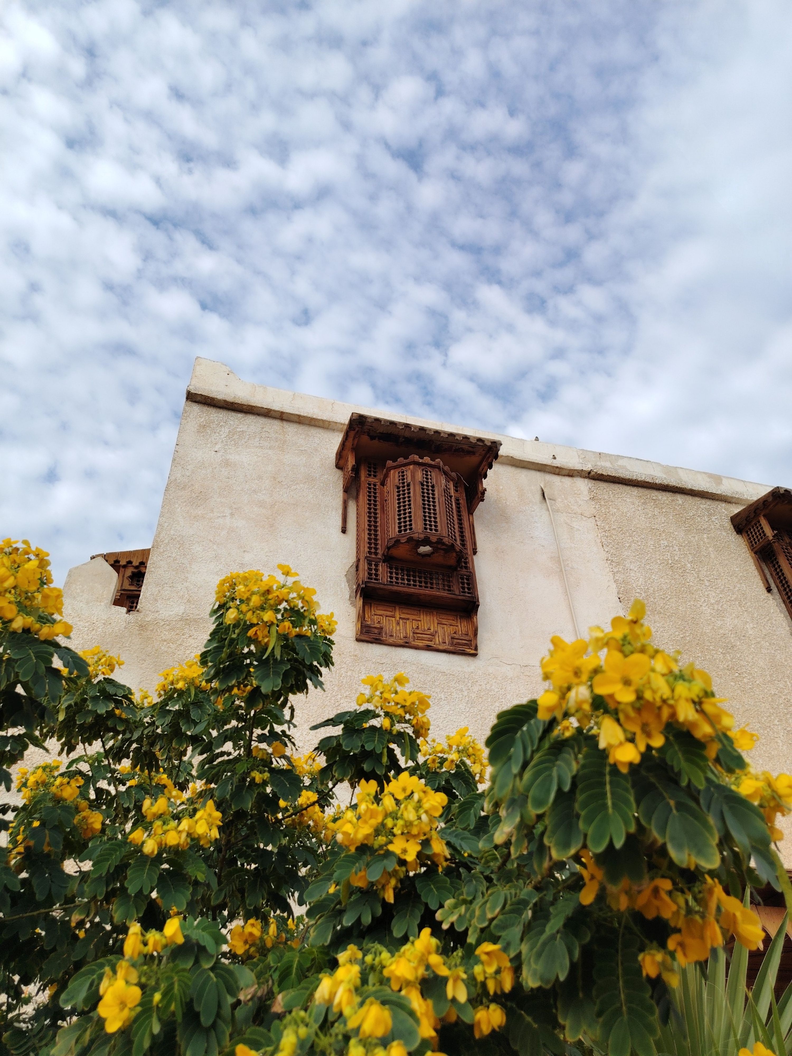 Traditional Architecture with Yellow Flowers · Free Stock Photo