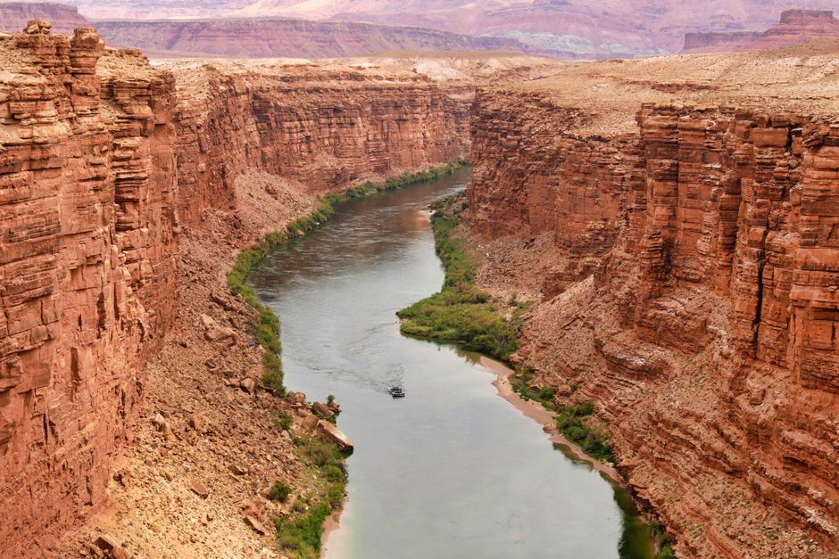45-minute Helicopter Flight Over the Grand Canyon from Tusayan, Arizona - Stunning view of a river cutting through red rock canyons, captured from above.