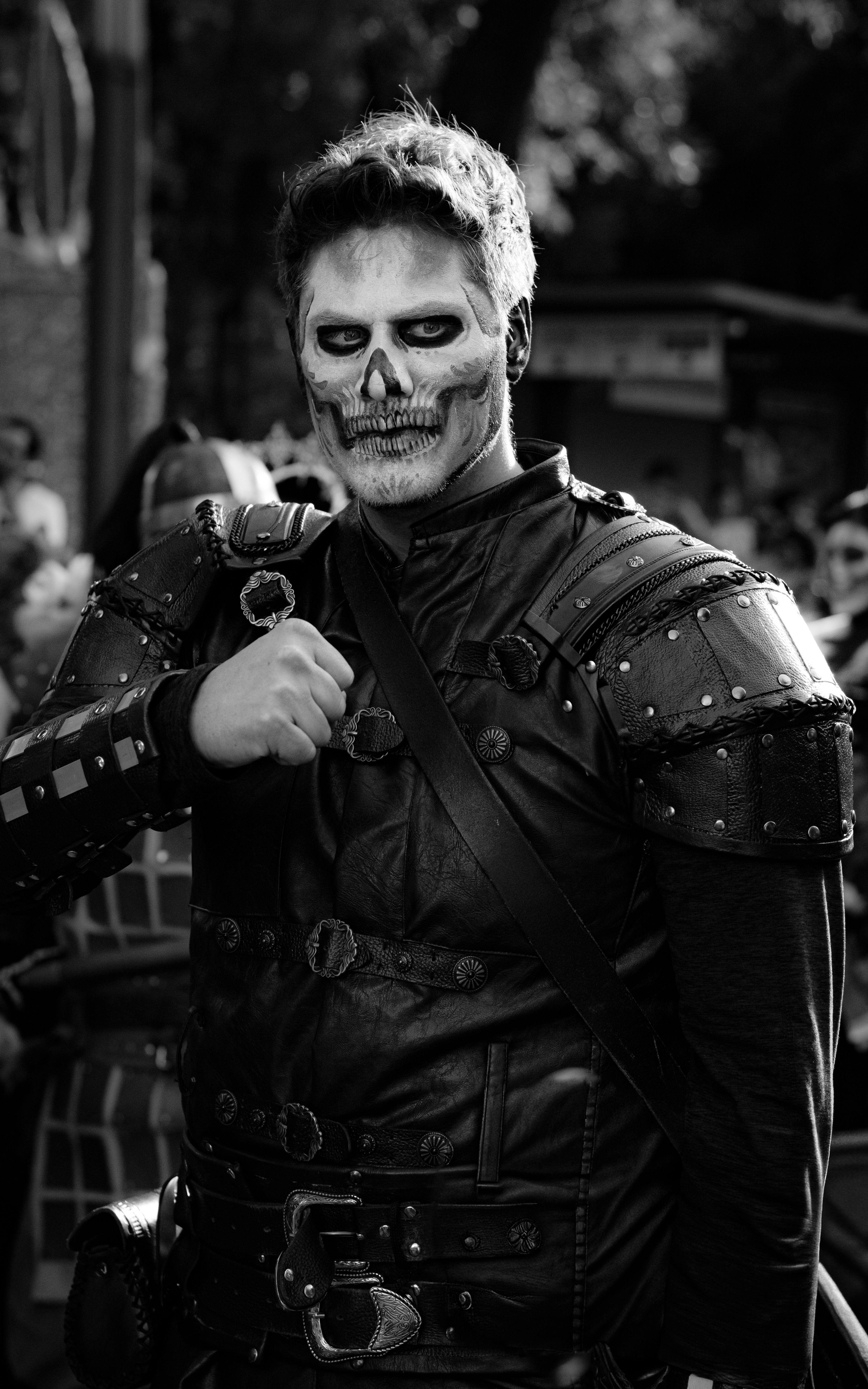 A dramatic black and white portrait of a man in a detailed skeleton costume, perfect for Halloween or Day of the Dead themes.