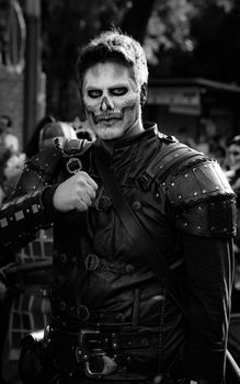 A dramatic black and white portrait of a man in a detailed skeleton costume, perfect for Halloween or Day of the Dead themes.
