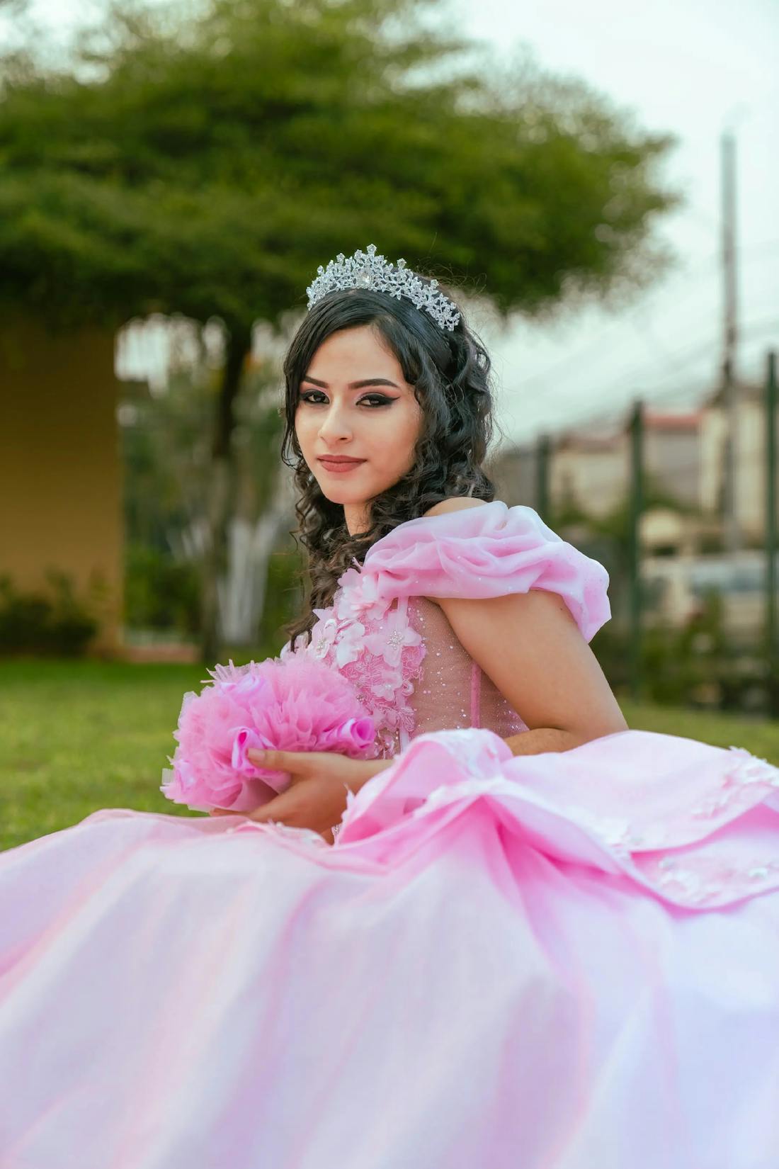Teen celebrating in a shimmering pink ball-gown