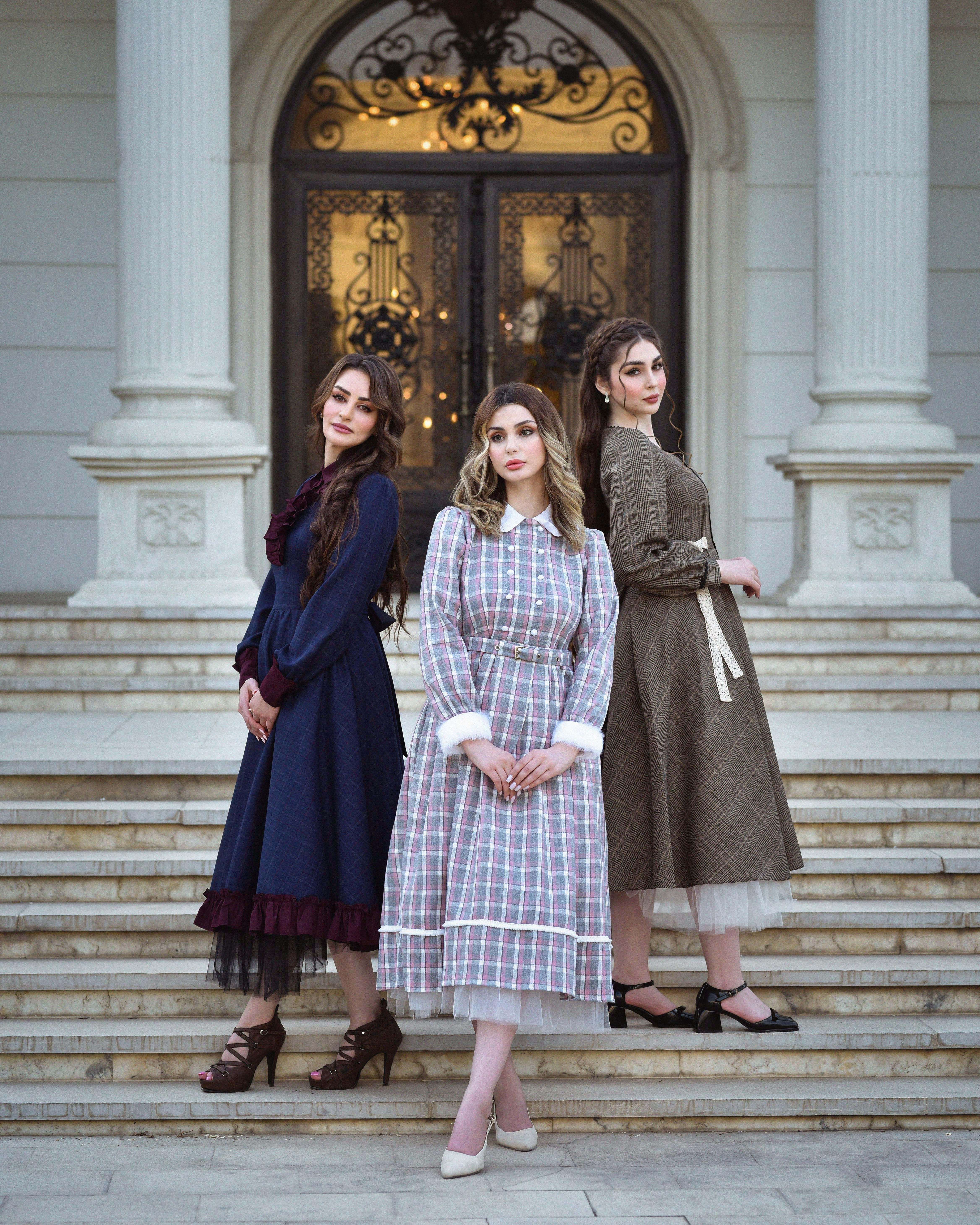 Free Three women in vintage dresses pose gracefully on manor steps. Beautiful and elegant fashion portrait. Stock Photo Free Three women in vintage dresses pose gracefully on manor steps. Beautiful and elegant fashion portrait. Stock Photo