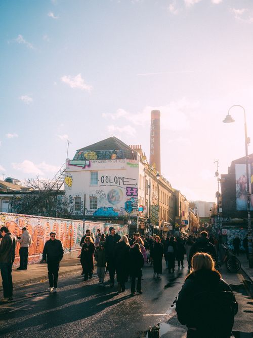 Free Bustling street scene in Camden, London with colorful graffiti and urban energy. Stock Photo