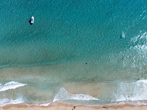 Free A stunning aerial view of Glyfada Beach in Corfu, Greece, showcasing azure waters and sandy shores. Stock Photo