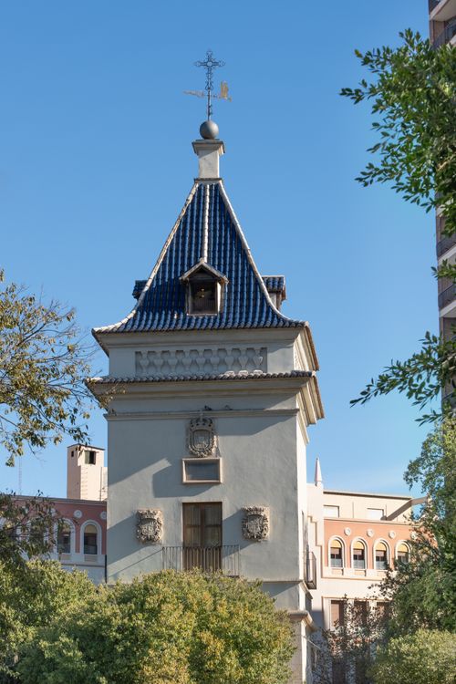 Free A historic architectural tower in Valencia, Spain surrounded by greenery on a clear day. Stock Photo