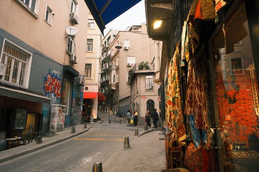 Cozy İstanbul street with colorful shops and graffiti art, capturing the city's vibrant urban life.