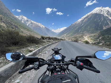 Explore scenic mountain roads on a motorcycle journey under blue skies.