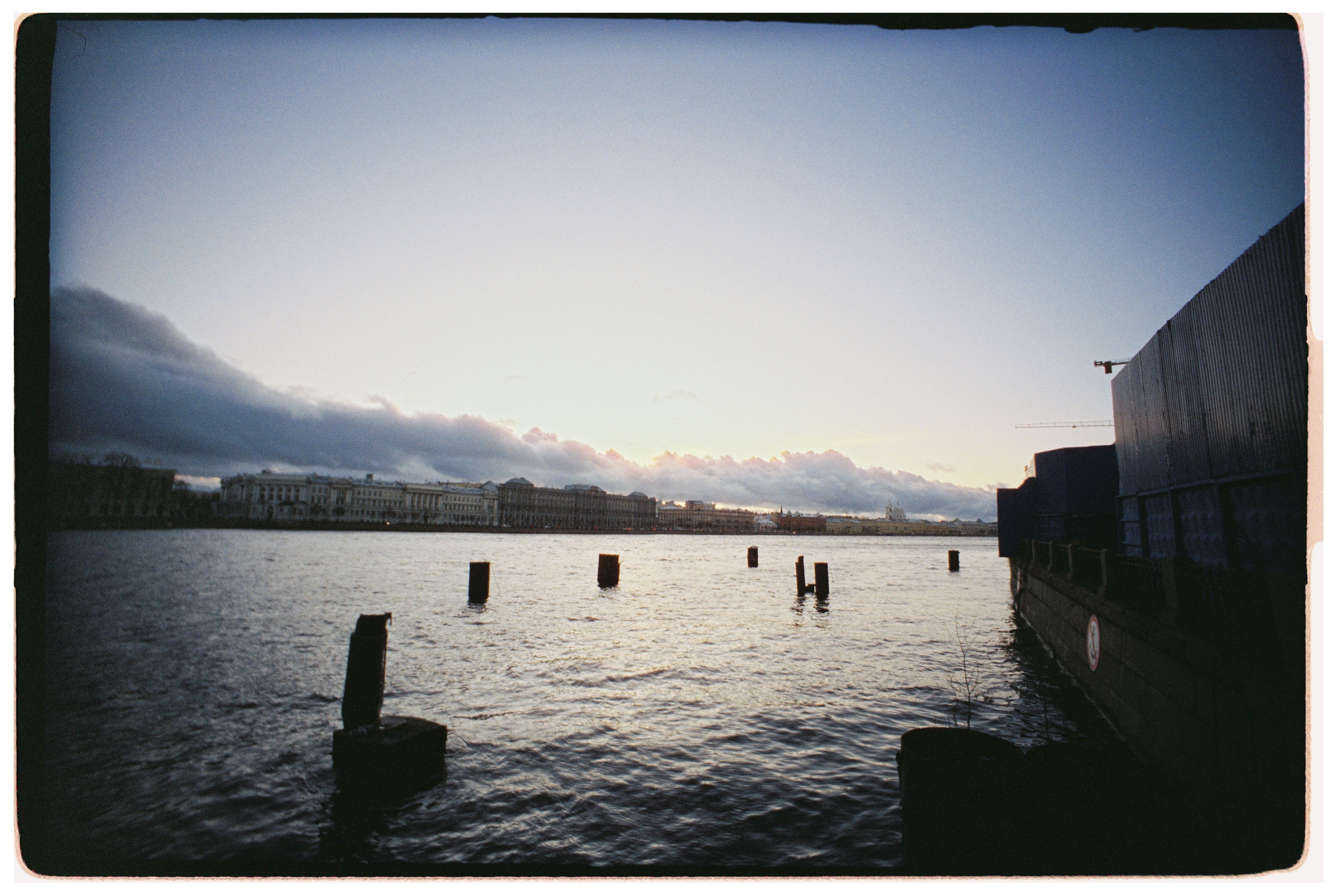 Sunset over Urban Waterfront Scene with Clouds · Free Stock Photo