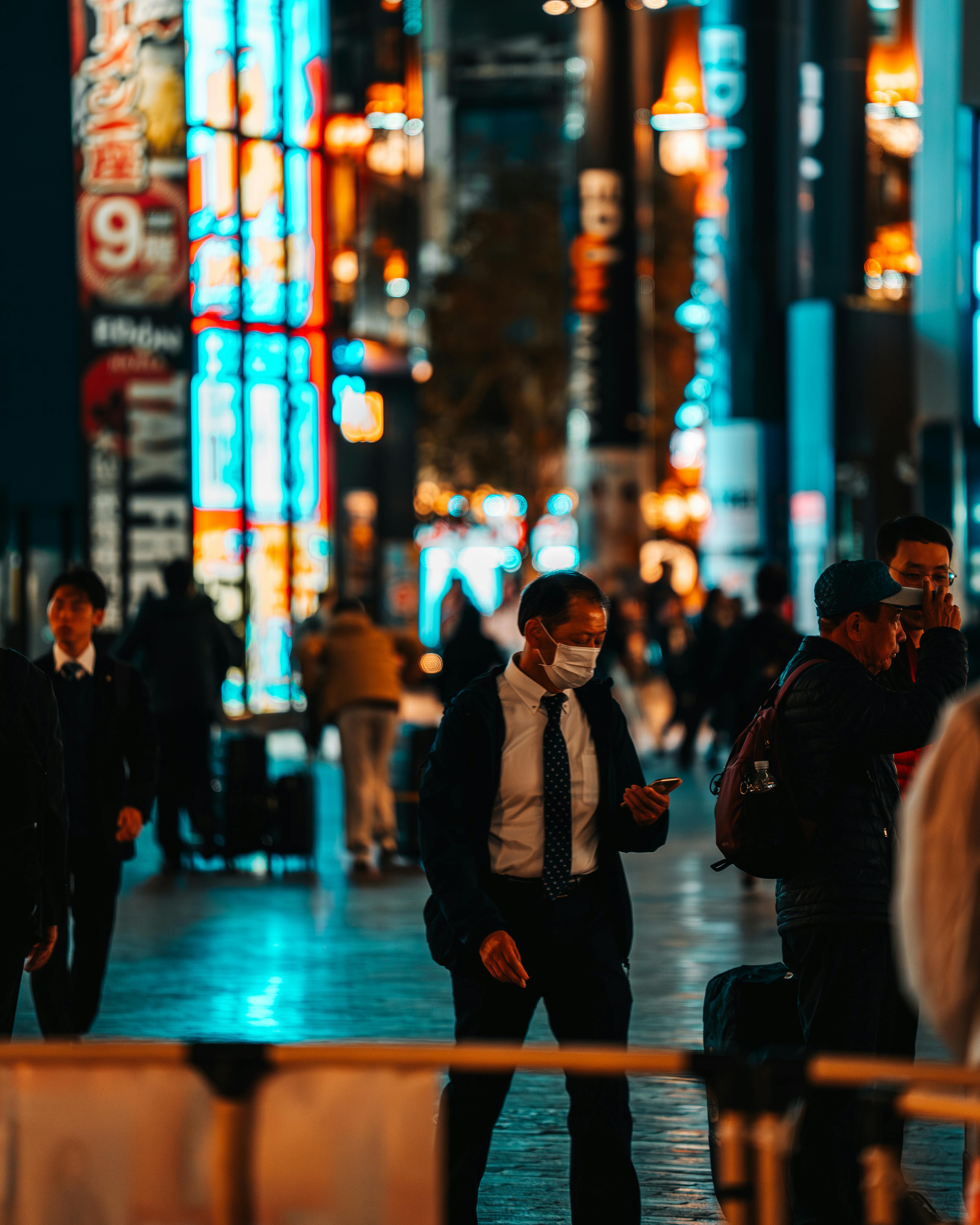 Experience the bustling nightlife in Dotonbori, Osaka with bright neon lights and busy streets.