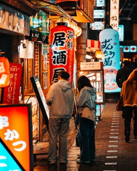 Explore the lively streets of Dotonbori in Osaka, Japan, filled with colorful lights and bustling nightlife.